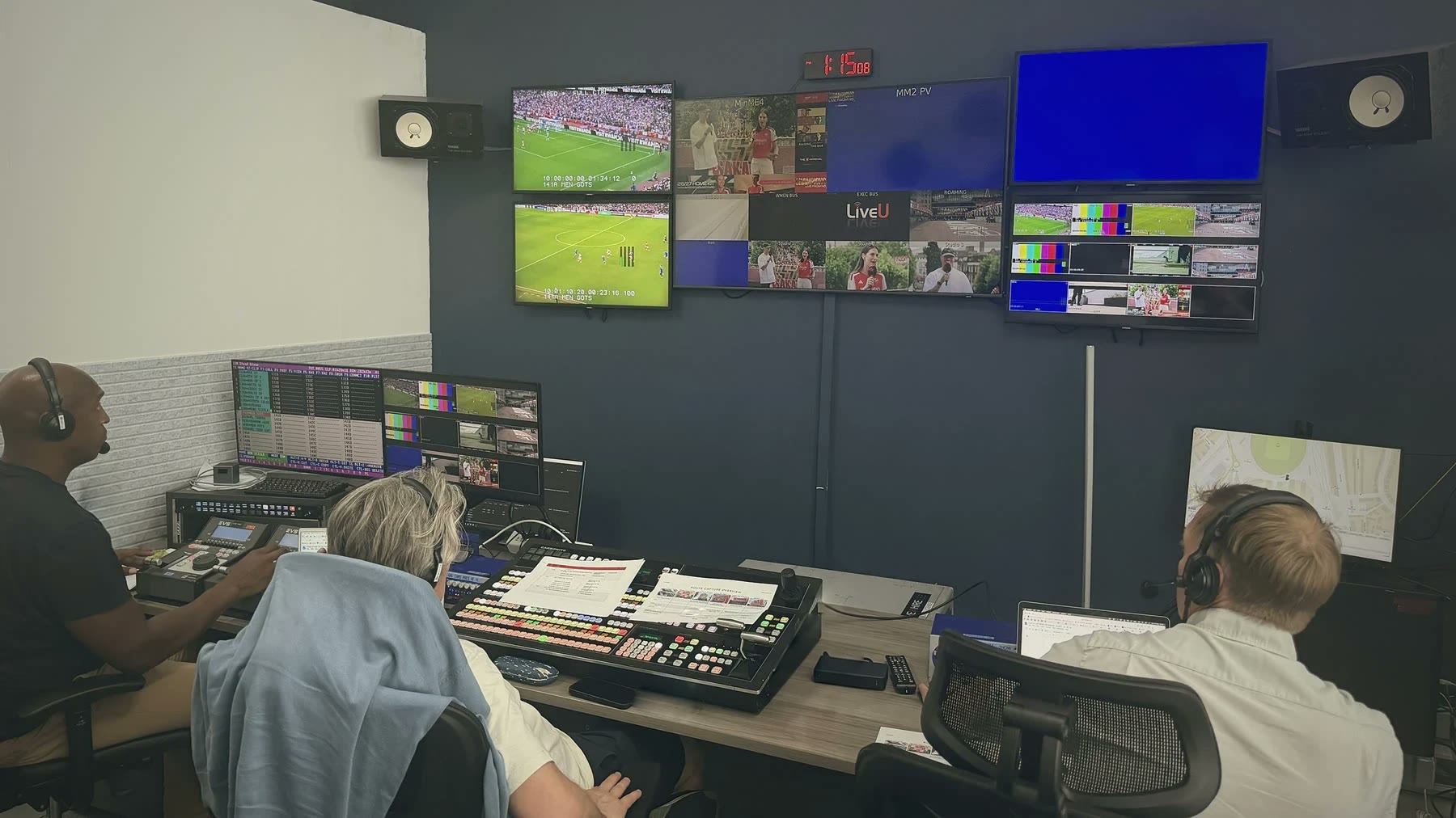 Replay, vision mixing and production positions in our control room, in front of the monitor wall.