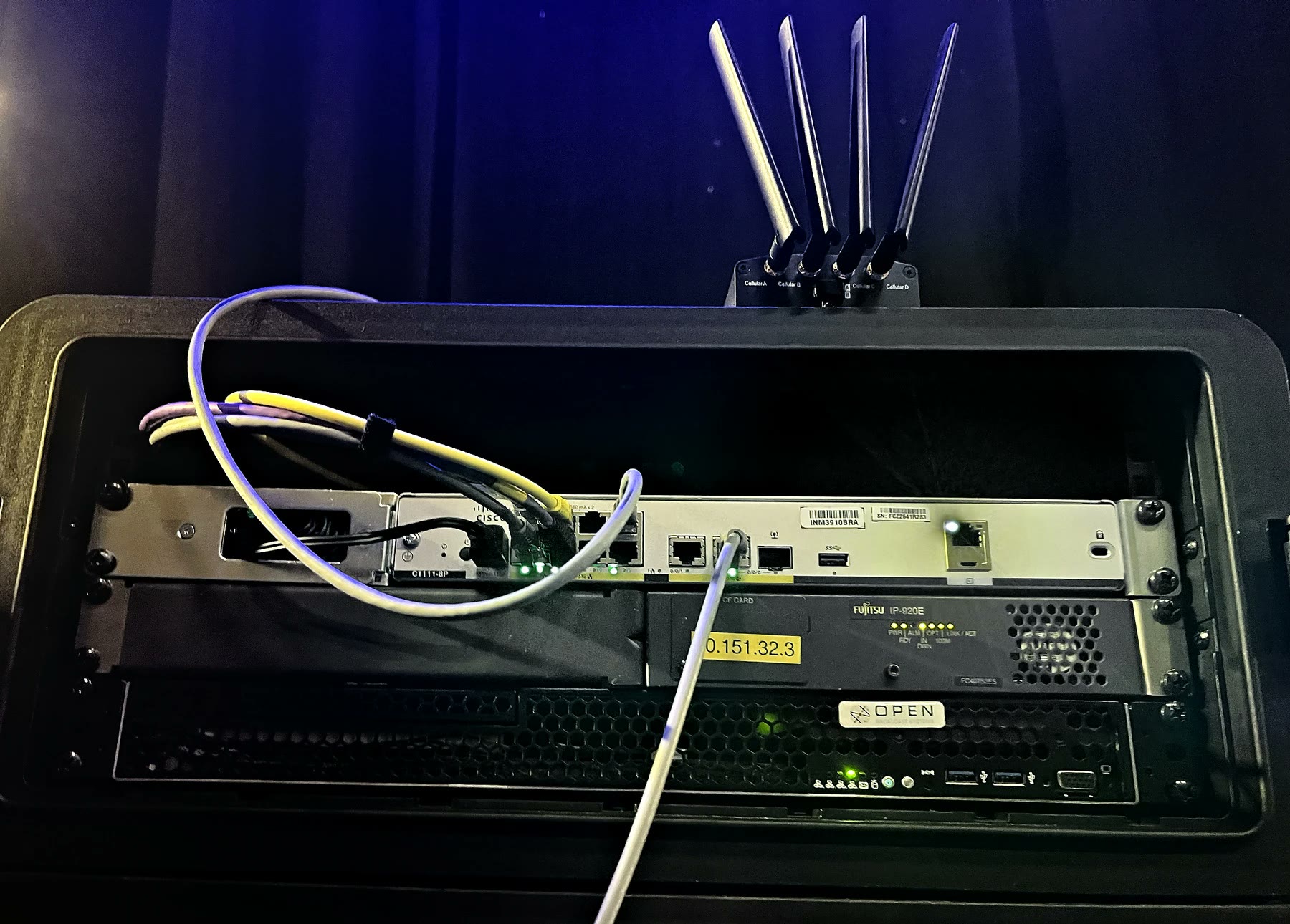 One of our touring kits in its flight case: a router, two encoders and a four-antenna cellular panel.